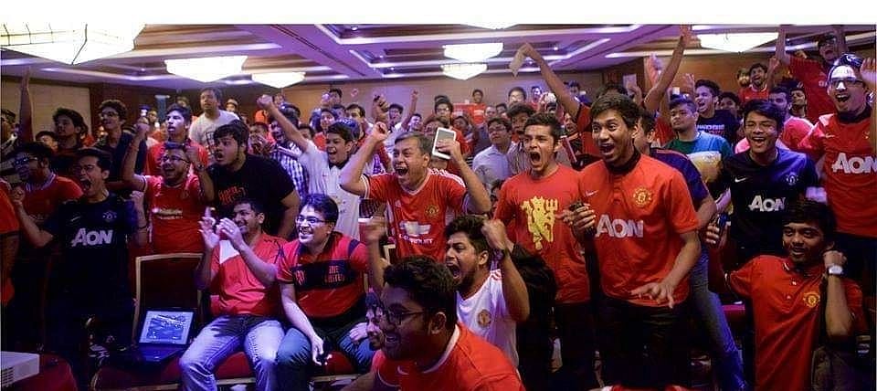 Manchester United Supporters Club Bangladesh members erupt in celebration after their team scores
