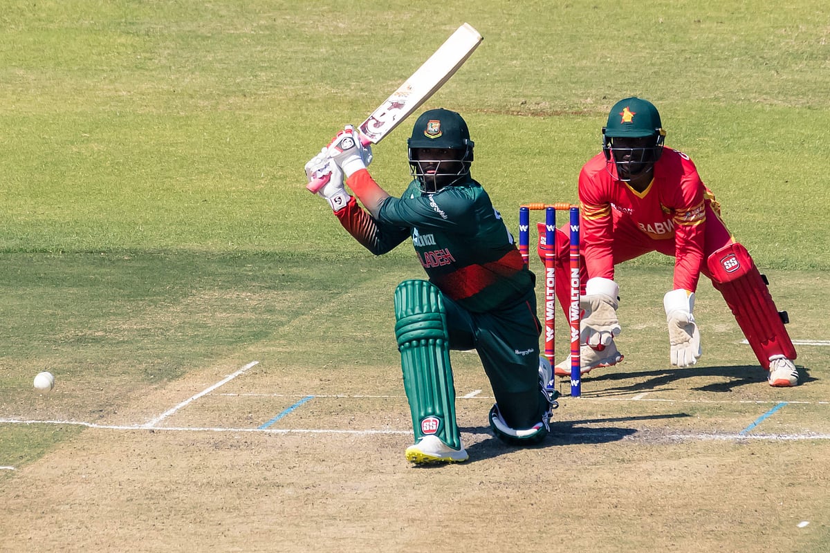 Bangladesh's Tamim Iqbal (L) plays a shot as Zimbabwe's wicketkeeper Regis Chakabva (R) looks on during the first One-Day International (ODI) between Zimbabwe and Bangladesh at the Harare Sports Club on 5 August, 2022