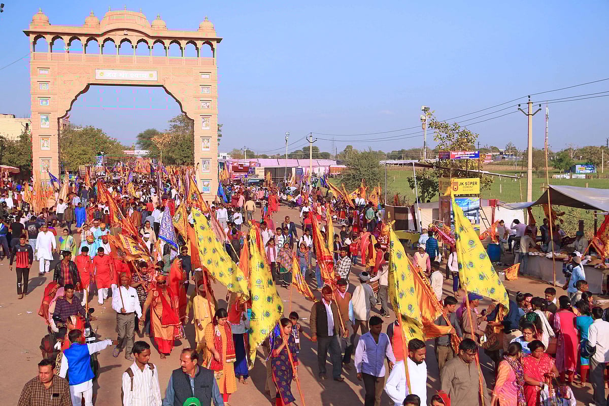 Devotees with religious flags arrives to participate annual 10 days fair at Khatu Shyam Ji Temple on the eve of Fagun month according to hindu calender at Sikar in Rajasthan on Saturday.