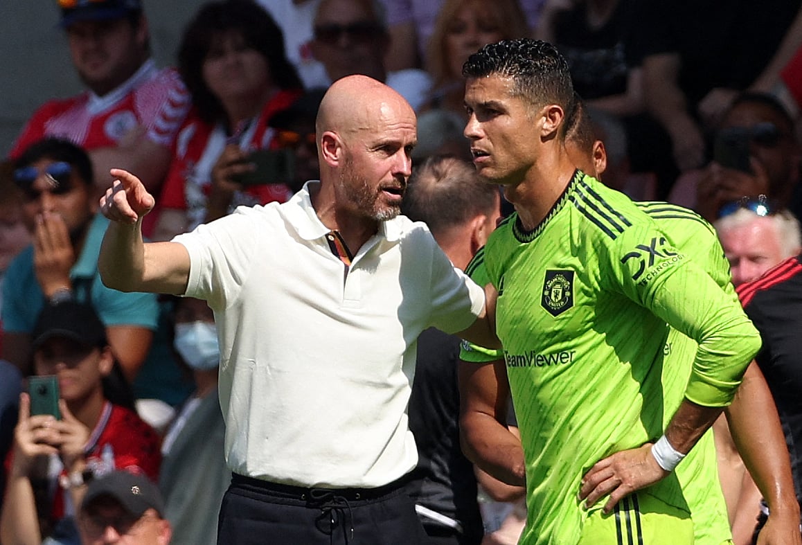 Manchester United's Dutch manager Erik ten Hag (L) directs substitute Manchester United's Portuguese striker Cristiano Ronaldo