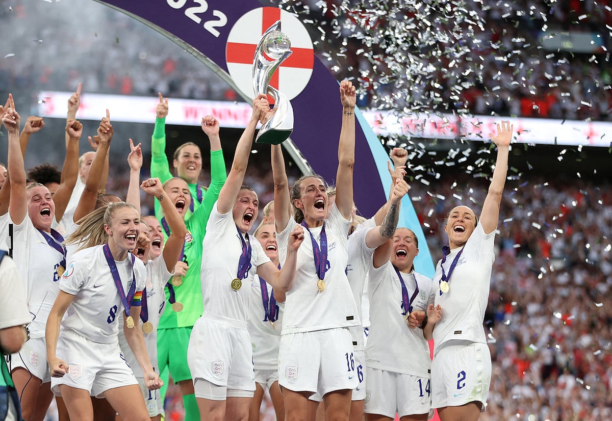 England's Ellen White and Jill Scott lift the trophy as they celebrate with teammates after winning Women's Euro 2022 on 1 August, 2022