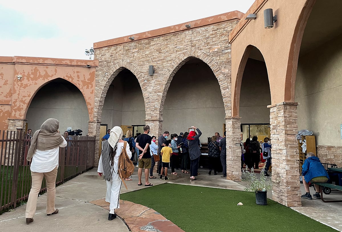 Participants in an interfaith memorial ceremony enter the New Mexico Islamic Center mosque to commemorate four murdered Muslim men, hours after police said they had arrested a prime suspect in the killings, in Albuquerque, New Mexico, US on 9 August, 2022.