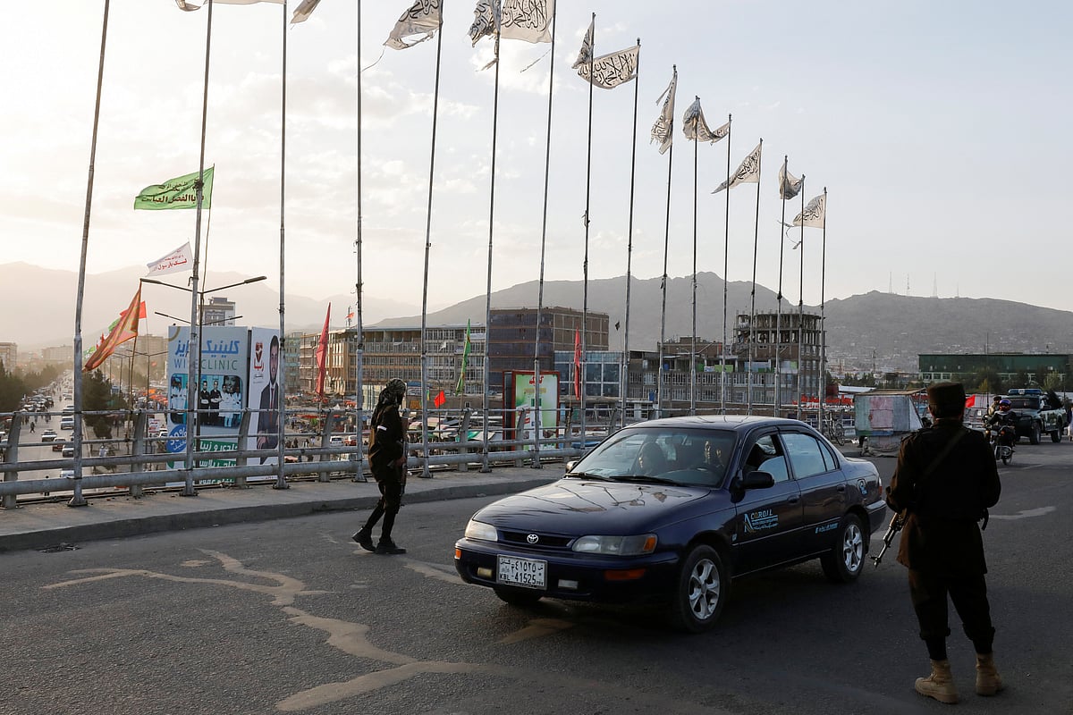 Taliban fighters stand guard at a checkpoint near the site of a blast in Kabul, Afghanistan, 6 August, 2022