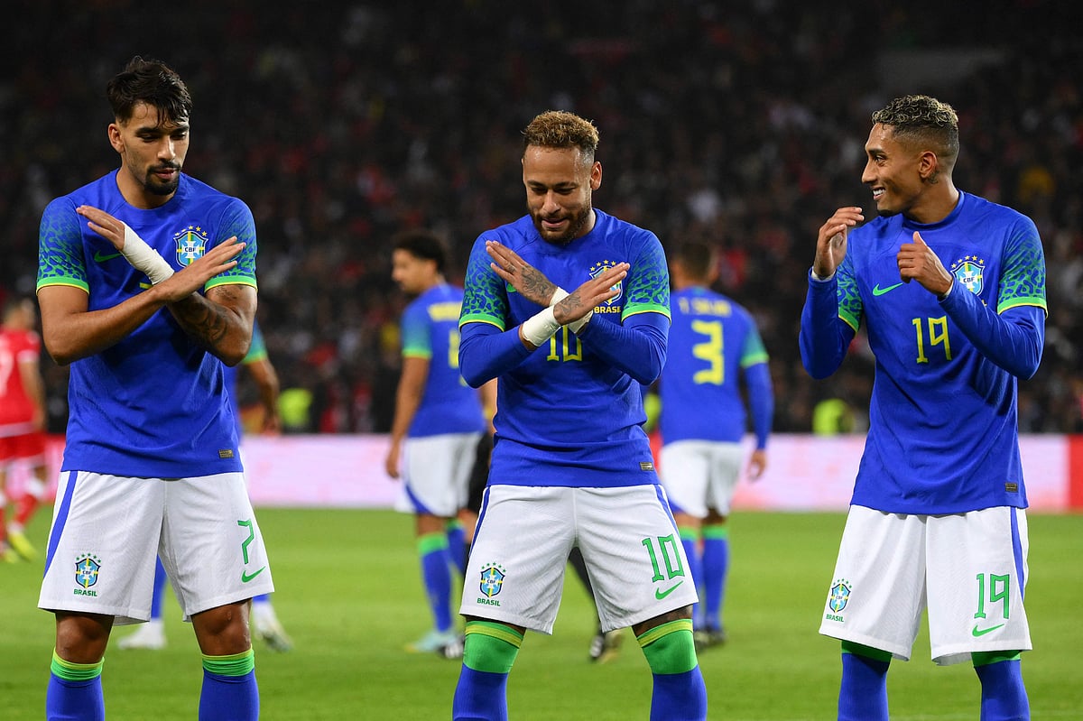 Brazil's forward Neymar (C) celebrates with his teammates Brazil's midfielder Lucas Paqueta (L) and Brazil's forward Raphinha (R) after scoring his team's third goal during a friendly match between Brazil and Tunisia at the Parc des Princes in Paris on 27 September, 2022