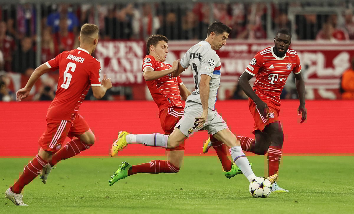 FC Barcelona's Robert Lewandowski in action with Bayern Munich's Joshua Kimmich, Benjamin Pavard and Dayot Upamecano during the first leg of their UEFA Champions League group-stage match at the Allianz Arena in Munich, Germany on 4 September, 2022