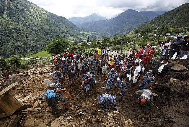 Rescue team members search for landslide victims at Lumle village in Kaski district on 30 July, 2015.