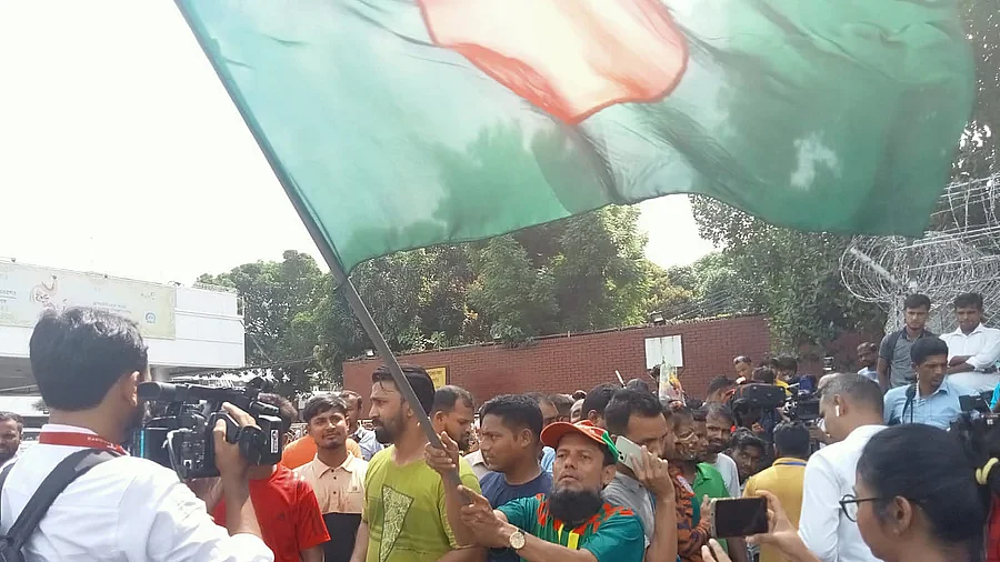 A fan waves the Bangladesh flag outside of the Hazrat Shahjalal International airport in Dhaka on 21 September, 2022