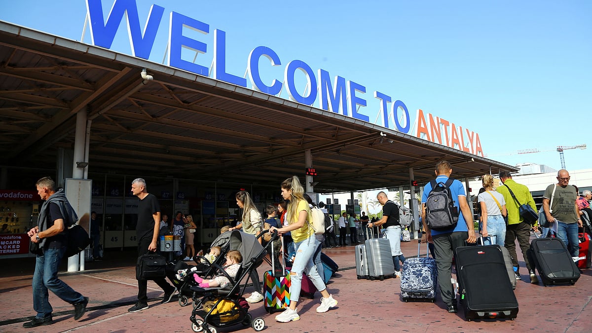 Tourists, coming mainly from Russia, leave from the arrival terminal at Antalya International Airport in the Mediterranean resort city of Antalya, Turkey on 22 September, 2022