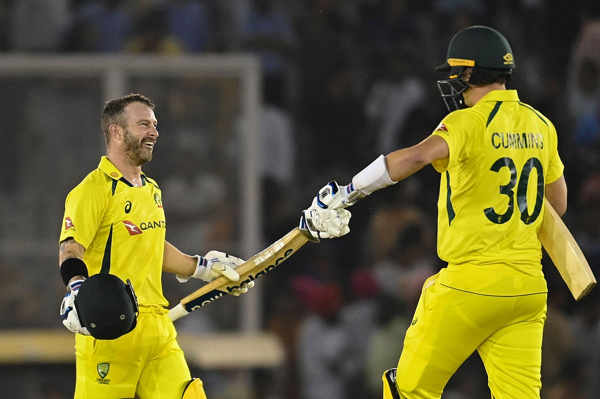 Australia's Matthew Wade (L) celebrates with teammate Pat Cummins after winning the first Twenty20 international cricket match between India and Australia at the Punjab Cricket Association Stadium in Mohali on 20 September, 2022