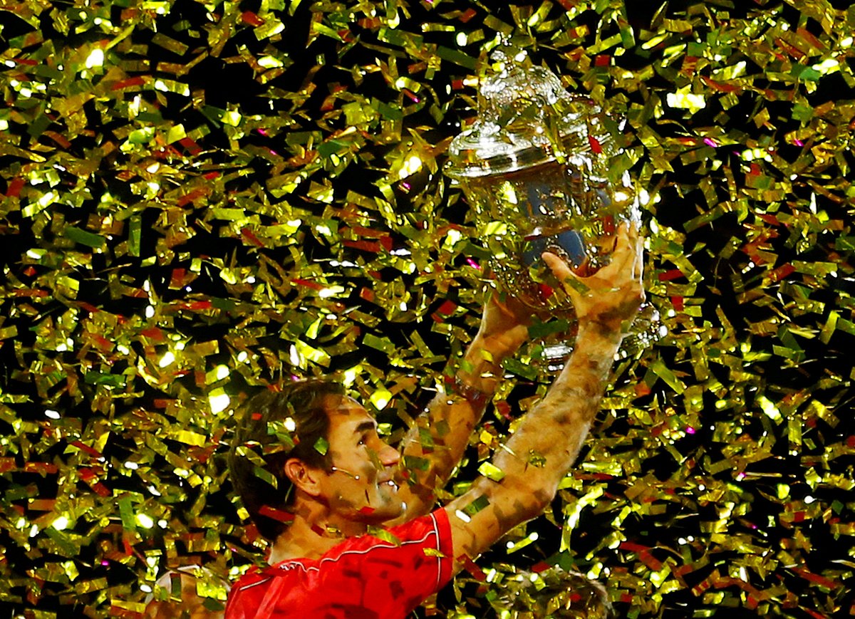 In this file photo from 27 October, 2019, Switzerland's Roger Federer celebrates with the trophy after winning the final against Australia's Alex de Minaur.