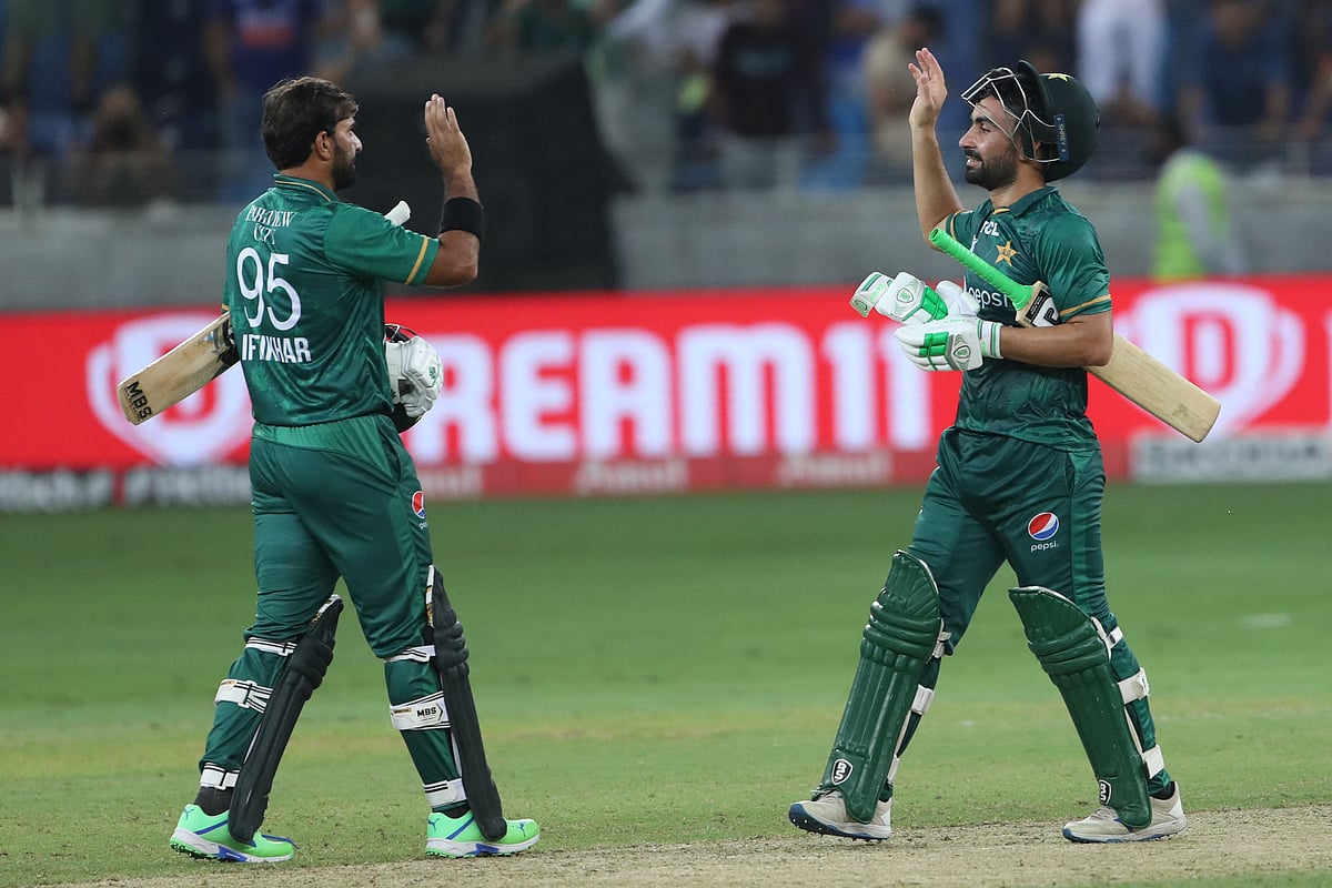 Pakistan's Khushdil Shah (R) celebrates with teammate Iftikhar Ahmed after their win at the end of the Asia Cup Twenty20 international cricket Super Four match between India and Pakistan at the Dubai International Cricket Stadium in Dubai on 4 September, 2022