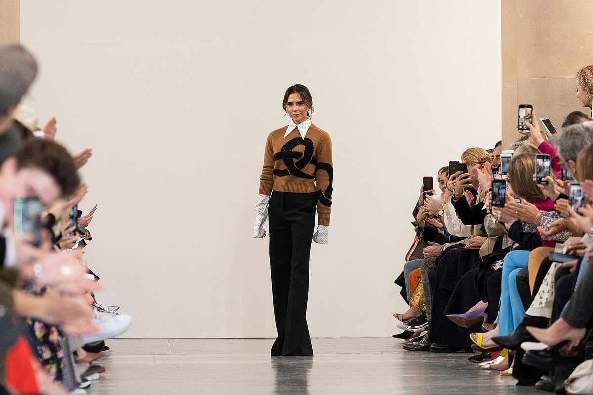 In this file photo taken on 17 February, 2019 British designer Victoria Beckham acknowledges the crowd during her 2019 Autumn / Winter collection catwalk show at London Fashion Week in London. After New York and London, Victoria Beckham created excitement by joining Paris Fashion Week, the most important fashion event of the year which begins on 26 September, 2022.