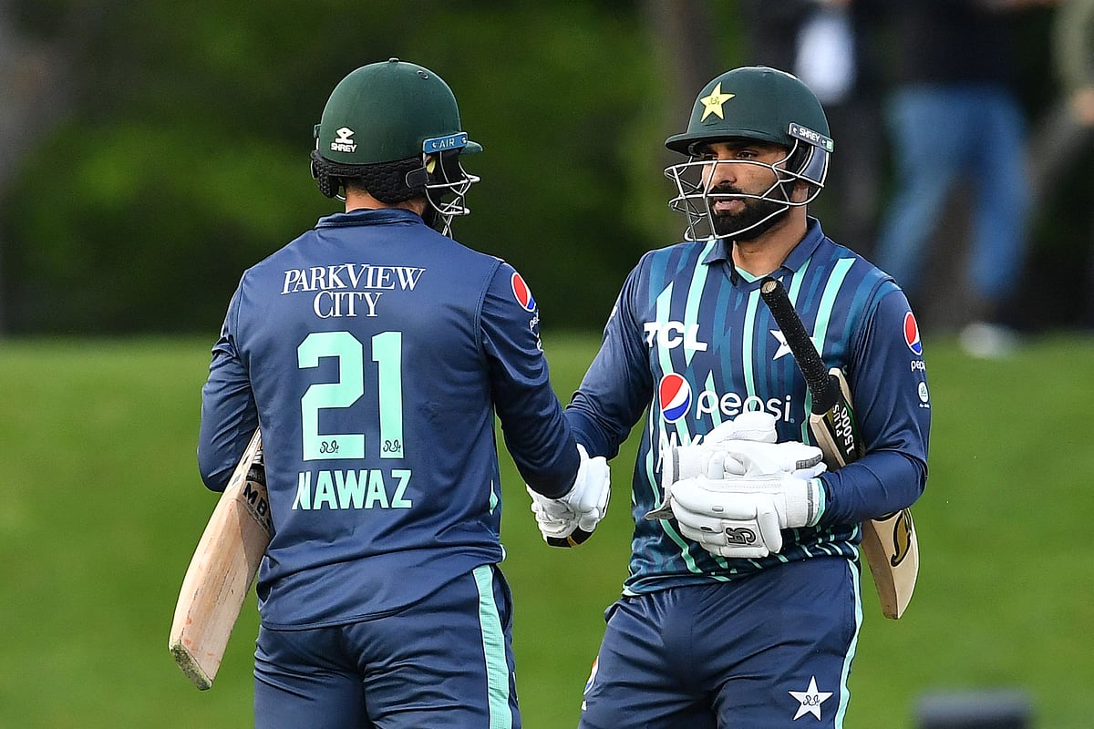 Pakistan's Mohammad Nawaz (L) and Asif Ali congratulate each other after their win during the Twenty20 tri-series cricket match between Pakistan and Bangladesh at Hagley Oval in Christchurch on 13 October, 2022