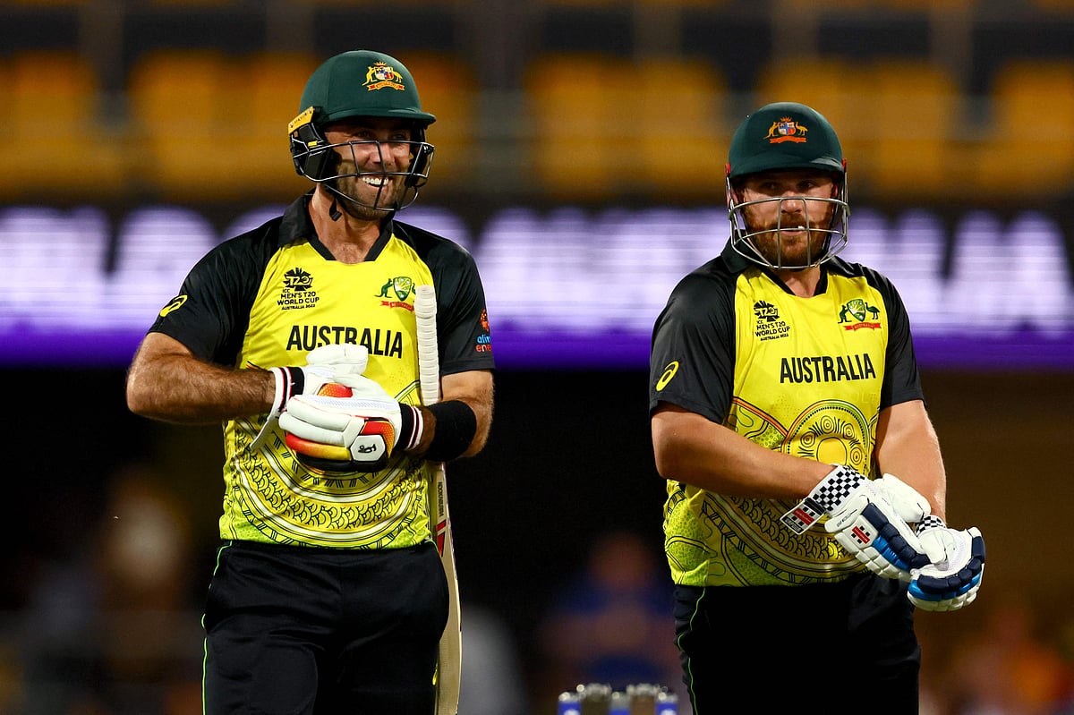 Australia's Glenn Maxwell (L) and Aaron Finch wait for the review decision during the ICC men's Twenty20 World Cup 2022 match between Australia and Ireland at The Gabba on 31 October, 2022 in Brisbane