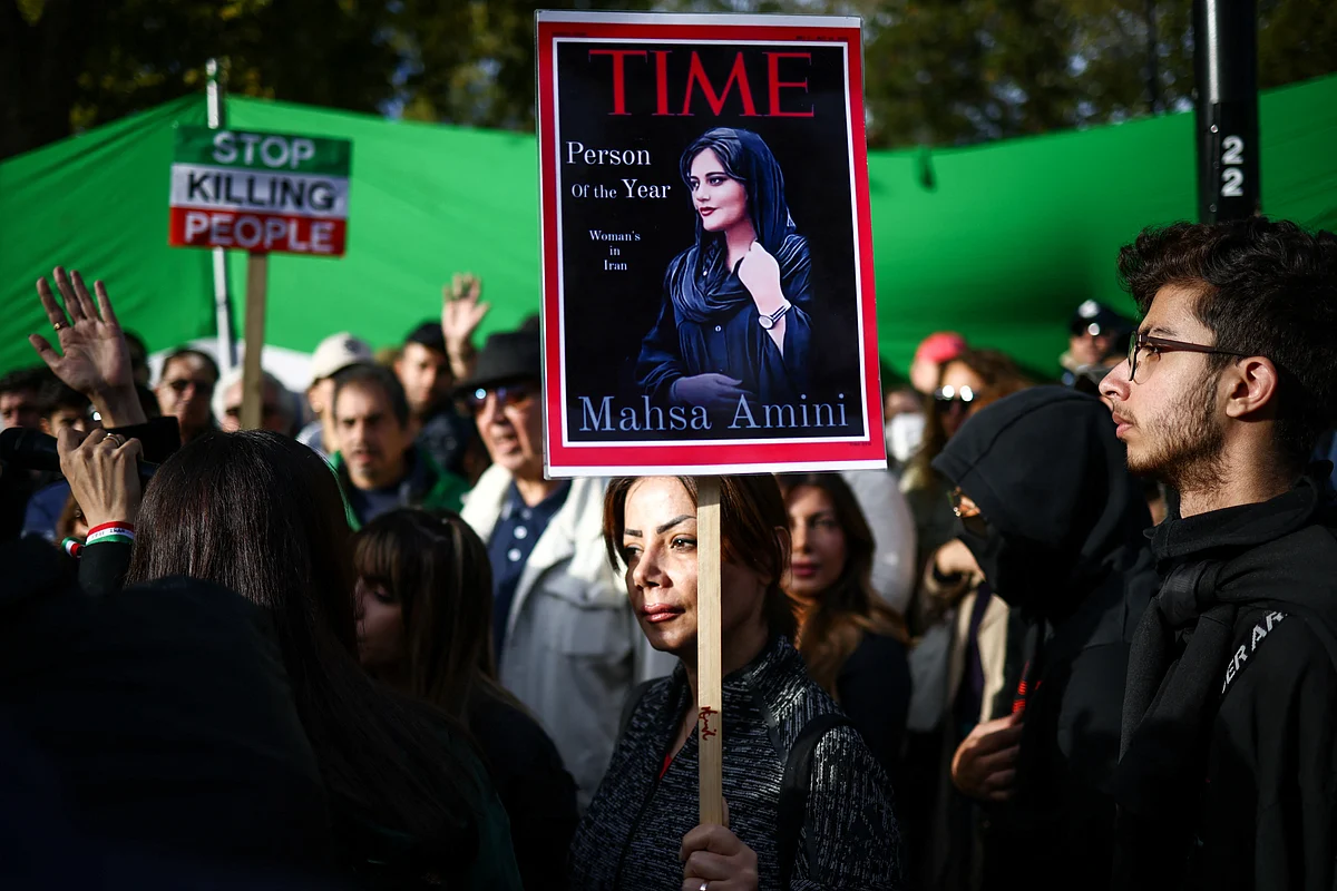 A woman holds a banner as people protest against the Iranian regime, following the death of Mahsa Amini, outside Iran's embassy in central London, Britain, 9 October, 2022.