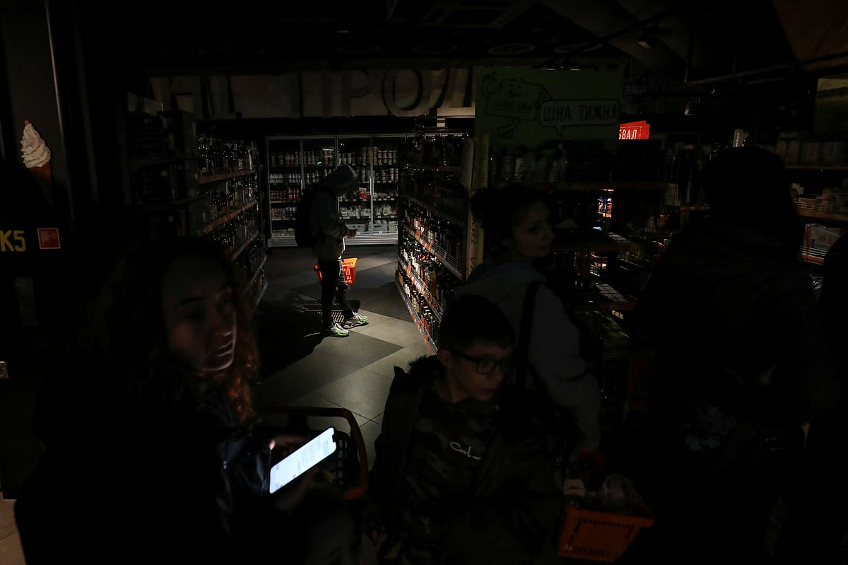 People visit a grocery store without electricity in the city centre, after a Russian missile attack in Lviv, Ukraine October 11, 2022