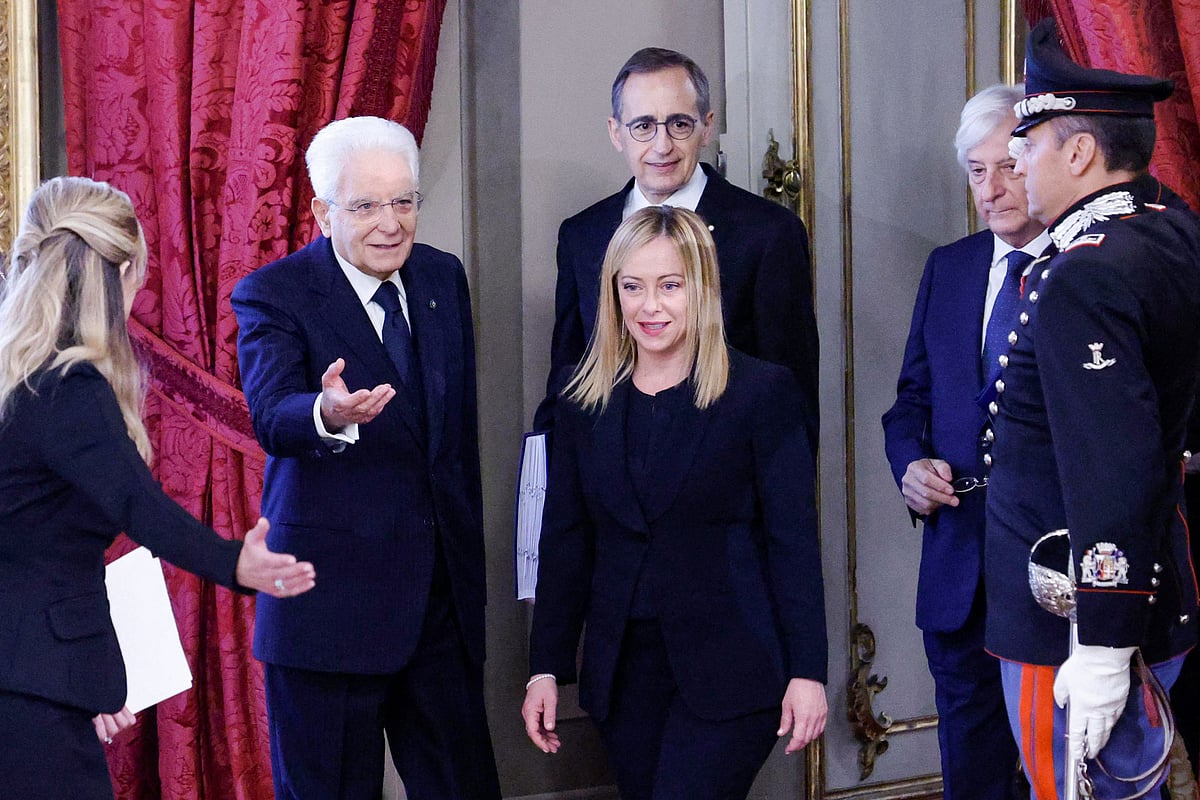 Italian President Sergio Mattarella (2nd L) welcomes new Prime Minister Giorgia Meloni (C) as she arrives for the swearing-in ceremony of the new Italian Government at the Quirinal Palace in Rome on 22 October, 2022