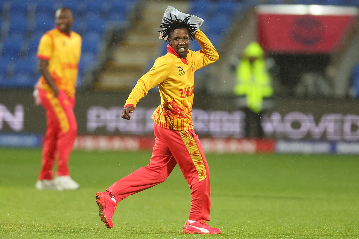 South Africa's Quinton de Kock chats with Zimbabwe's Regis Chakabva (R) as they walk off the field due to rain during the ICC men's Twenty20 World Cup 2022 cricket match between South Africa and Zimbabwe at Bellerive Oval in Hobart on 24 October 2022.