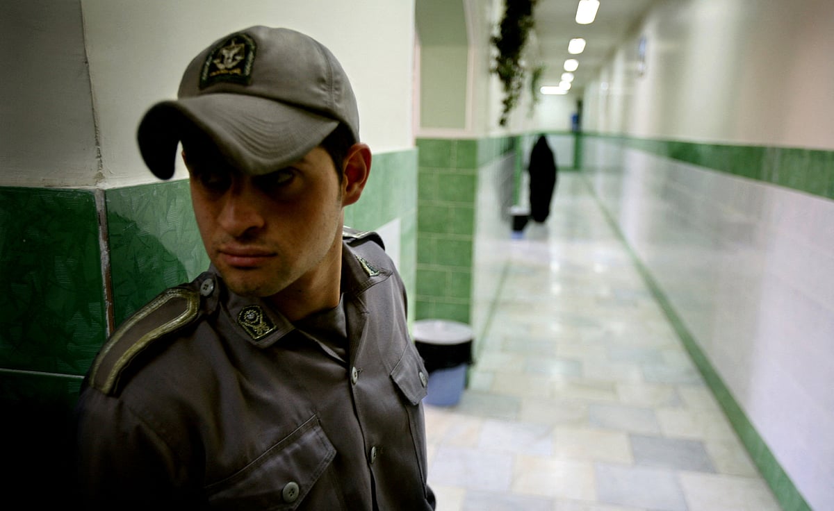 A prison guard stands along a corridor in Tehran's Evin prison June 13, 2006