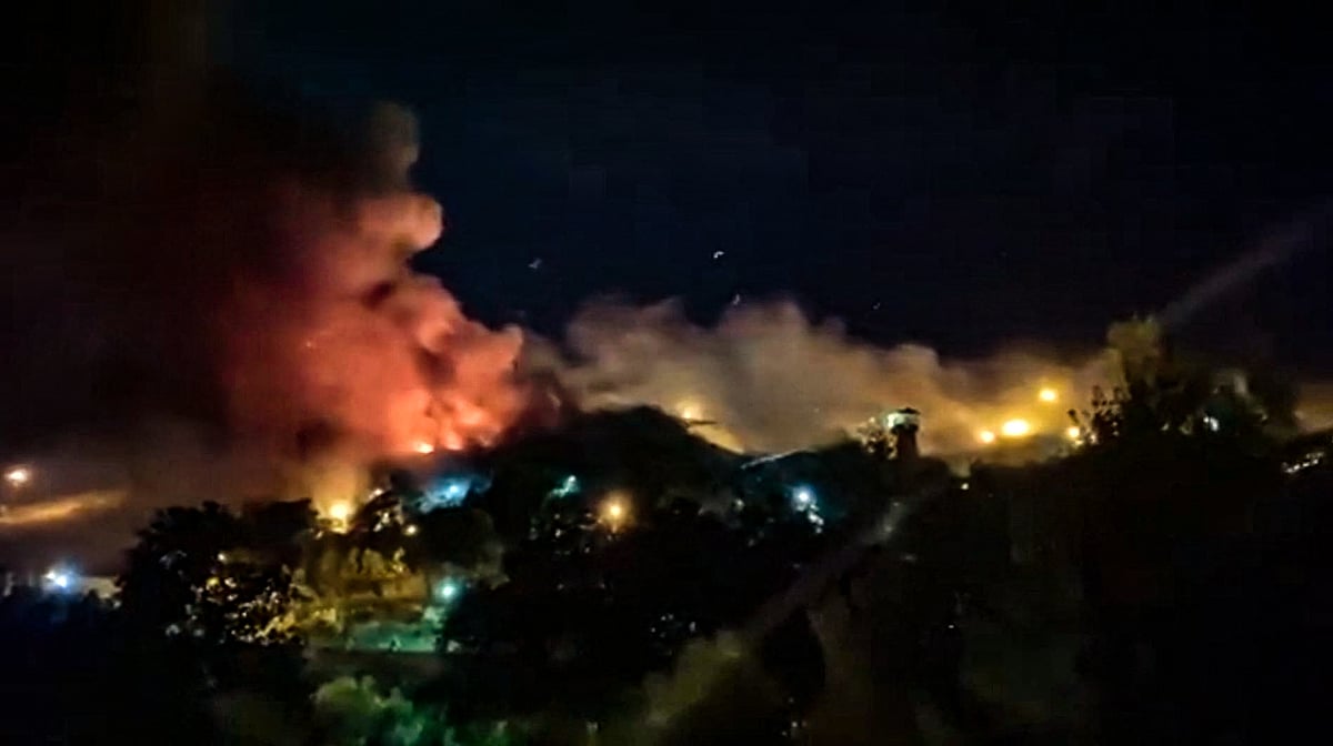 This image grab from a UGC video made available on 15 October, 2022, reportedly shows flames and thick smoke rising from the Evin prison, in the northwest of the Iranian capital Tehran