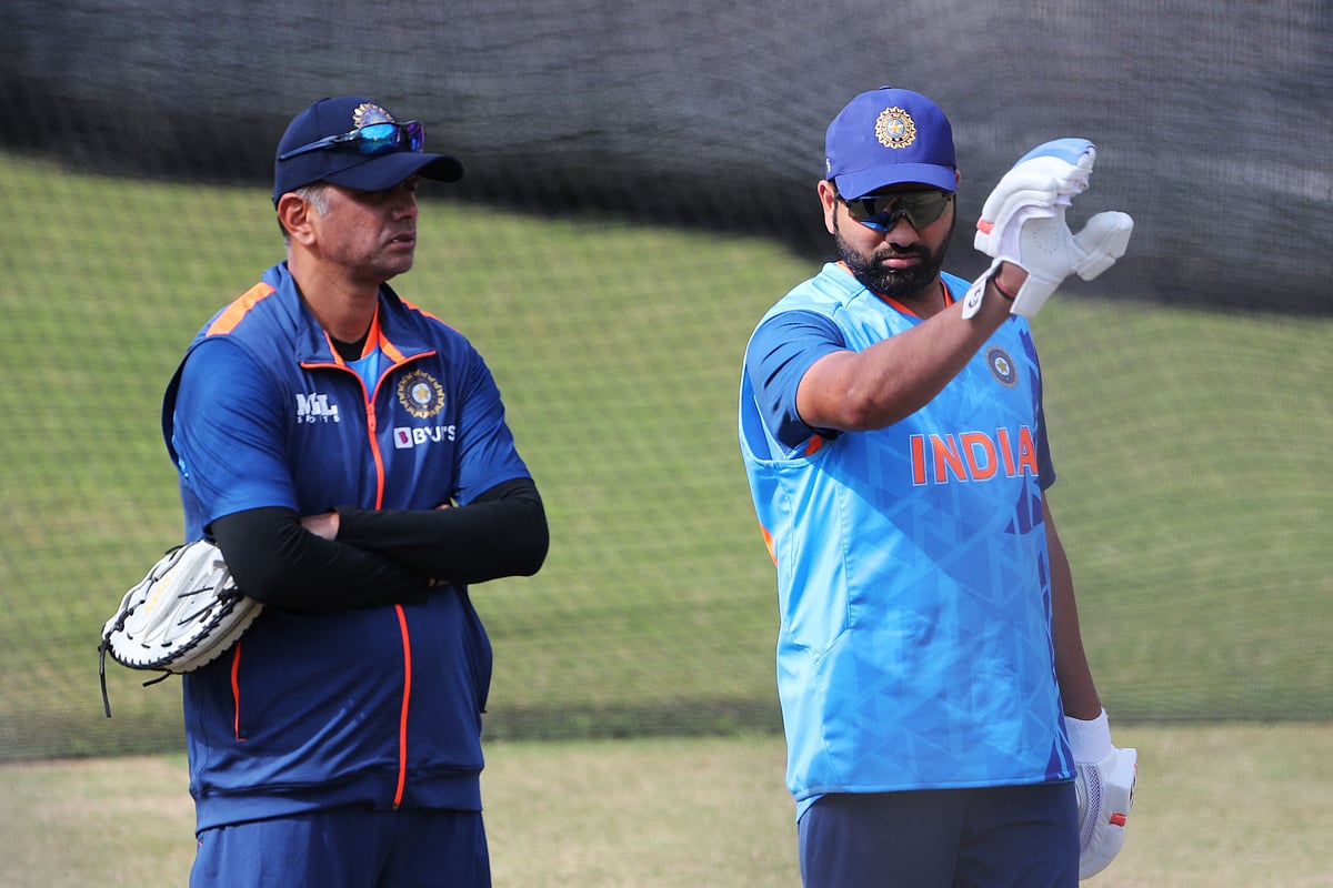 India's captain Rohit Sharma (R) speaks with India's head coach Rahul Dravid during a practice session ahead of their ICC men’s Twenty20 World Cup 2022 match against Pakistan, at the Melbourne Cricket Ground in Melbourne on 22 October, 2022