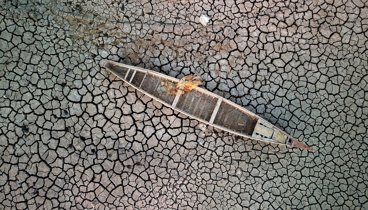 In this file aerial photo taken on 24 July, 2022 shows a boat on the dried-up bed of a section of Iraq's receding southern marshes of Chibayish in Dhi Qar province.