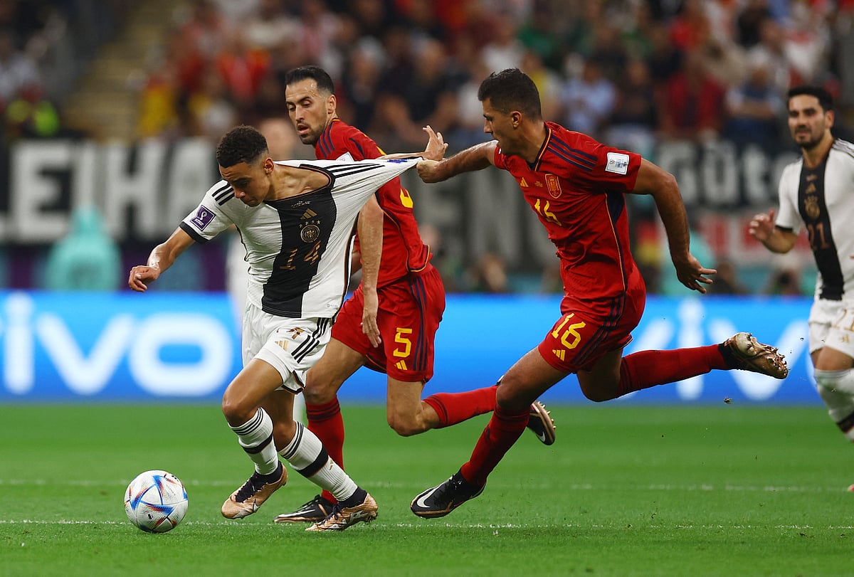 Spain's Sergio Busquets fouls Germany's Jamal Musiala before being shown yellow card in the FIFA World Cup 2022 Group E match Spain v Germany at the Al Bayt Stadium in Al Khor, Qatar on 27 November, 2022
