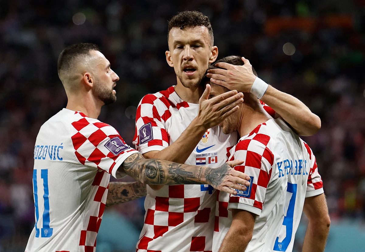 Croatia's Andrej Kramaric celebrates scoring their first goal with Ivan Perisic and Marcelo Brozovic at the FIFA World Cup 2022 Group F match Croatia v Canada at the Khalifa International Stadium, in Doha, Qatar on 27 November, 2022