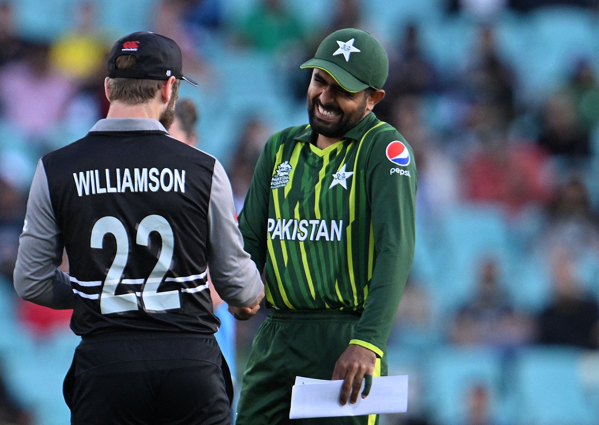 New Zealand's captain Kane Williamson (L) and Pakistan's captain Babar Azam share a light moment as they shake hands ahead of the start of the ICC men's Twenty20 World Cup 2022 semi-final cricket match between New Zealand and Pakistan at the Sydney Cricket Ground in Sydney on 9 November, 2022