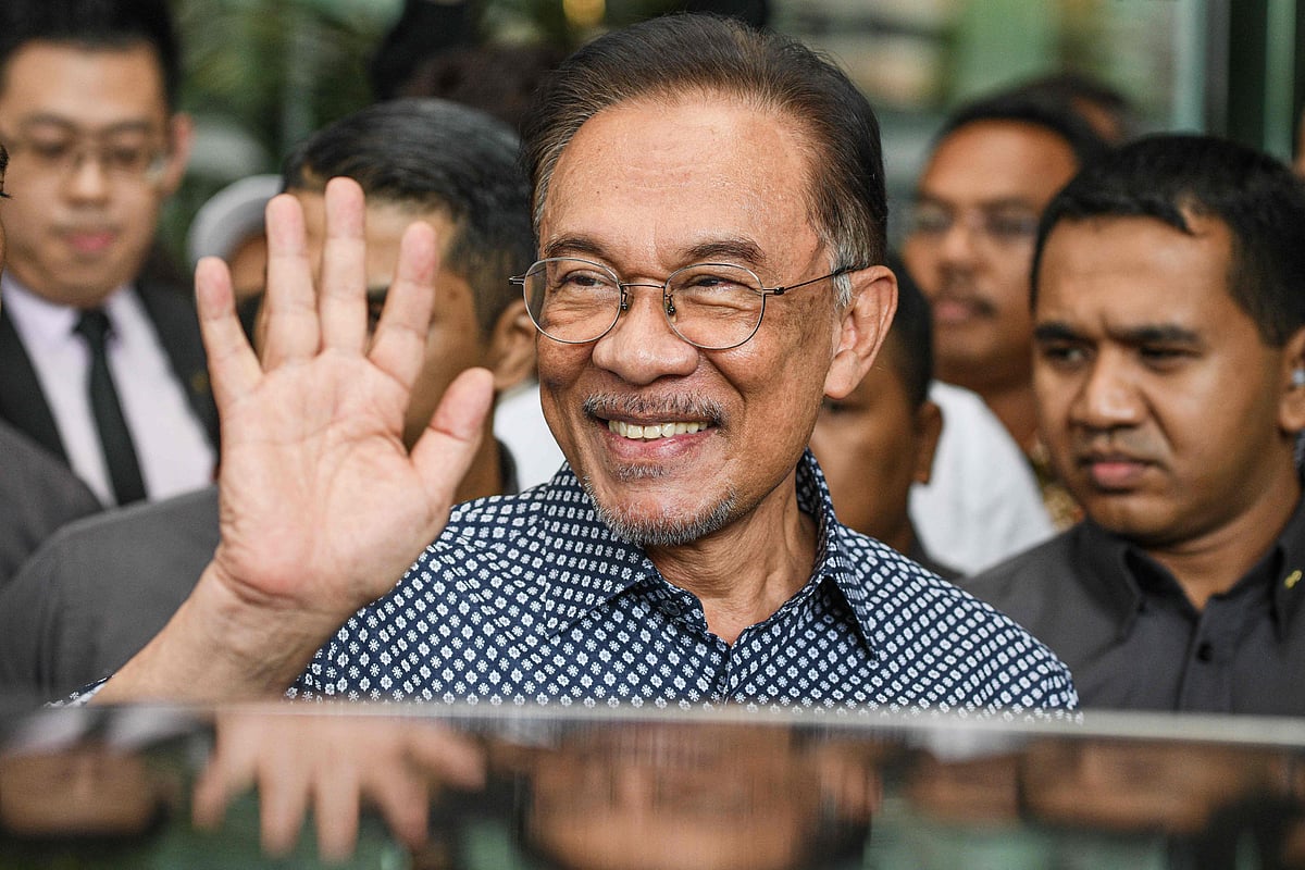 In this file photo taken on February 29, 2020, Malaysian politician Anwar Ibrahim waves as he leaves a hotel in Kuala Lumpur. Malaysian opposition leader Anwar Ibrahim has been appointed prime minister, the palace said in a statement on November 24, 2022, ending a days-long political impasse after inconclusive polls