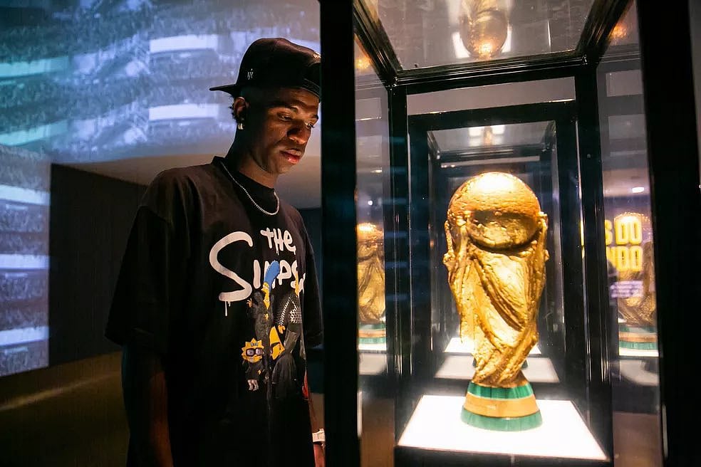 Brazil's Vinicius Junior looks at the FIFA World Cup trophy