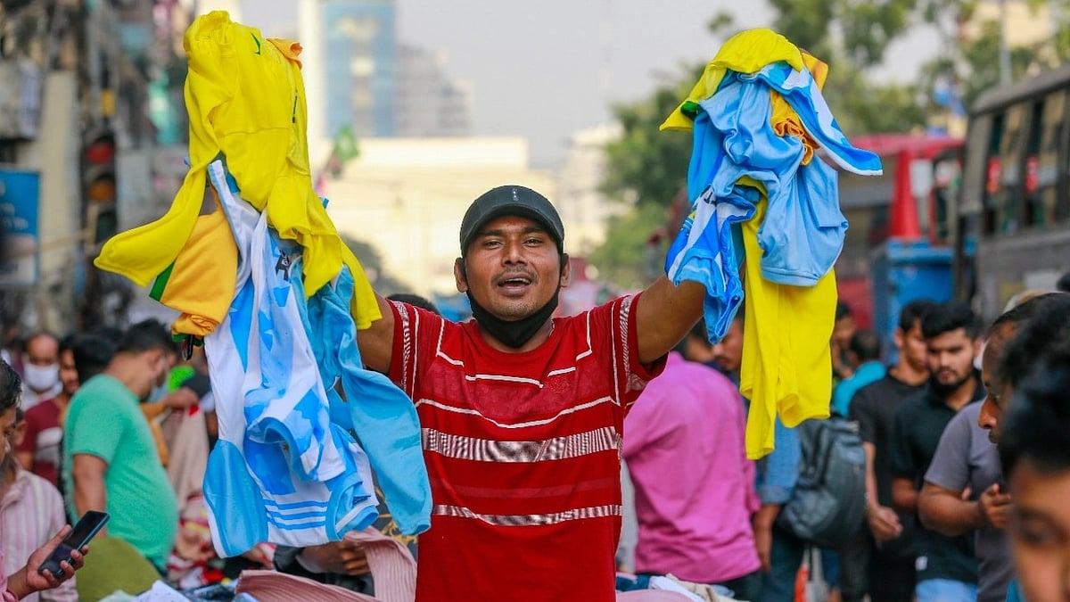 A hawker sells jersey on Dhaka street