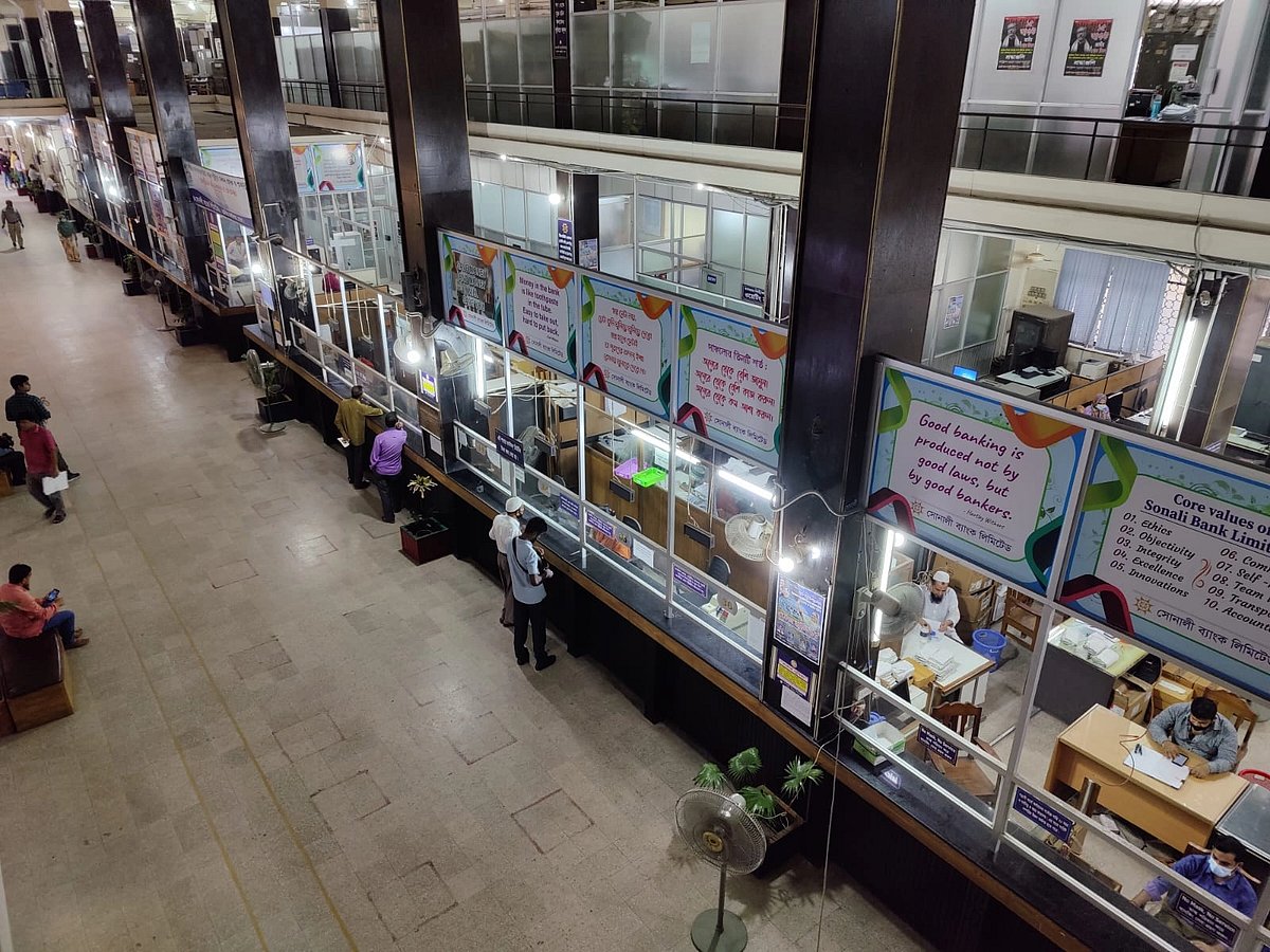 Photo shows customers receiving service at a bank