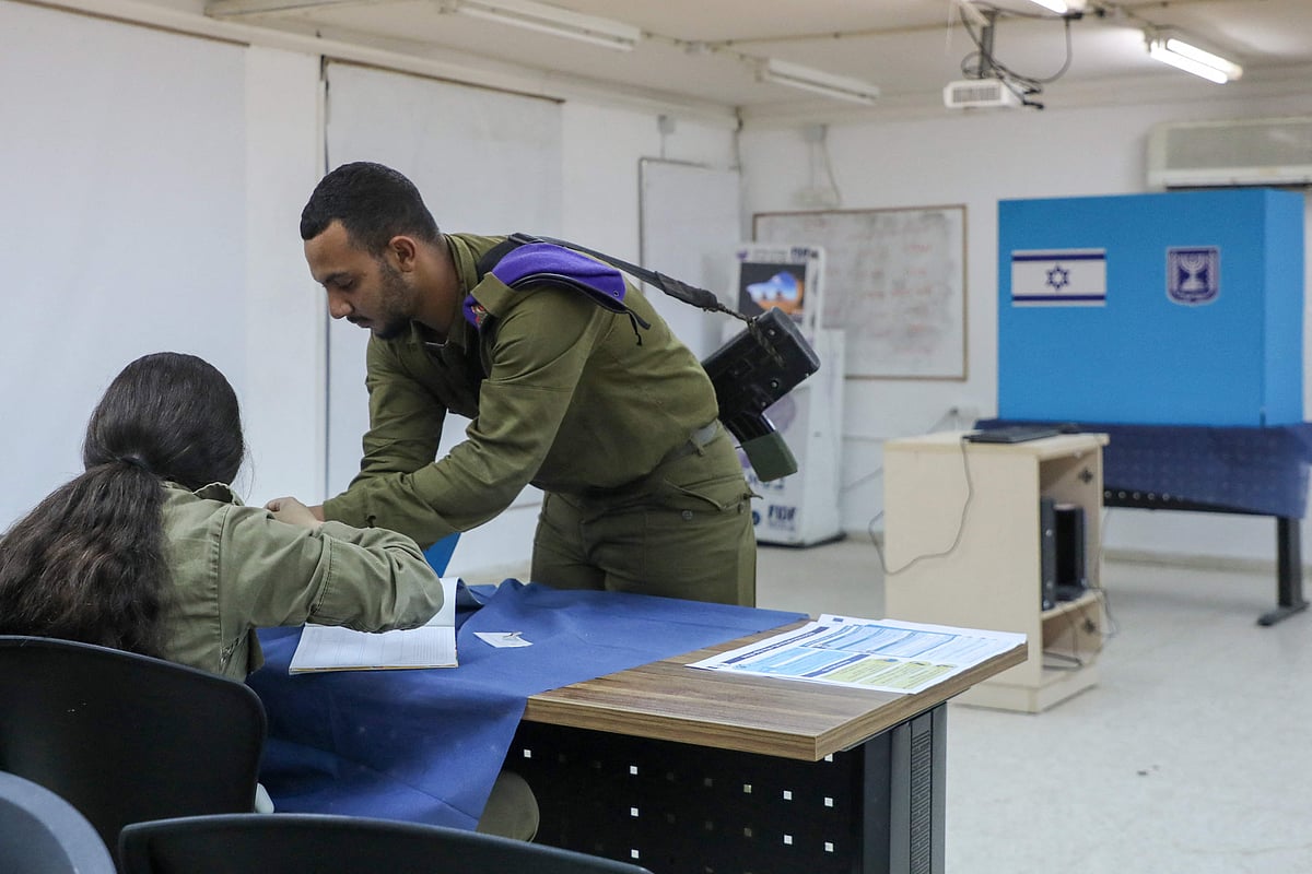 An Israeli soldier registers to cast his ballot a day early in the Israeli general elections at the Kerem Shalom army base in the south of Israel near the border with the Gaza strip on 31 October, 2022