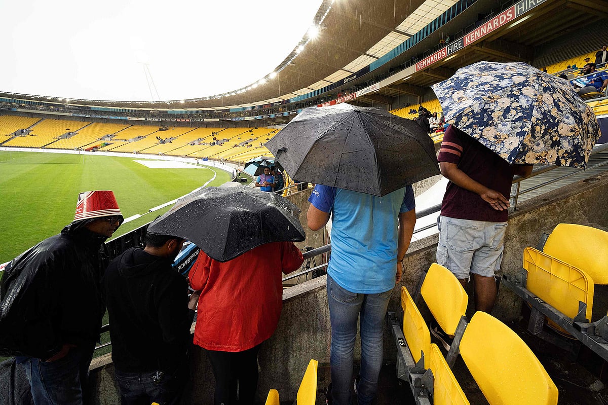 Spectators look on as rain keeps pouring down at the Sky Stadium in Wellington on 18 November, 2022