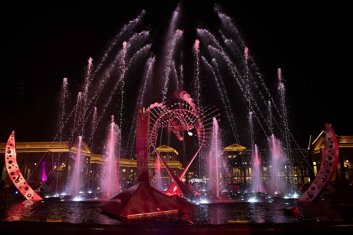 People attend a water show at Katara Cultural Village in Doha on 17 November, 2022, ahead of the Qatar 2022 World Cup