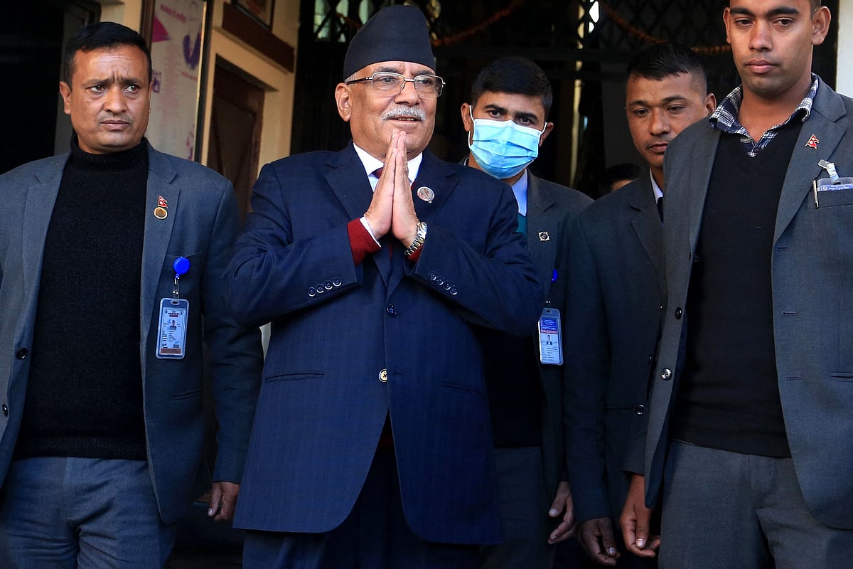 Nepal's former guerrilla leader Pushpa Kamal Dahal (2L), better known by his nom de guerre Prachanda gestures to media representatives as he leaves for the president's office to claim majority for his appointment as the new prime minister, in Bhaktapur on the outskirts of Kathmandu on 25 December, 2022