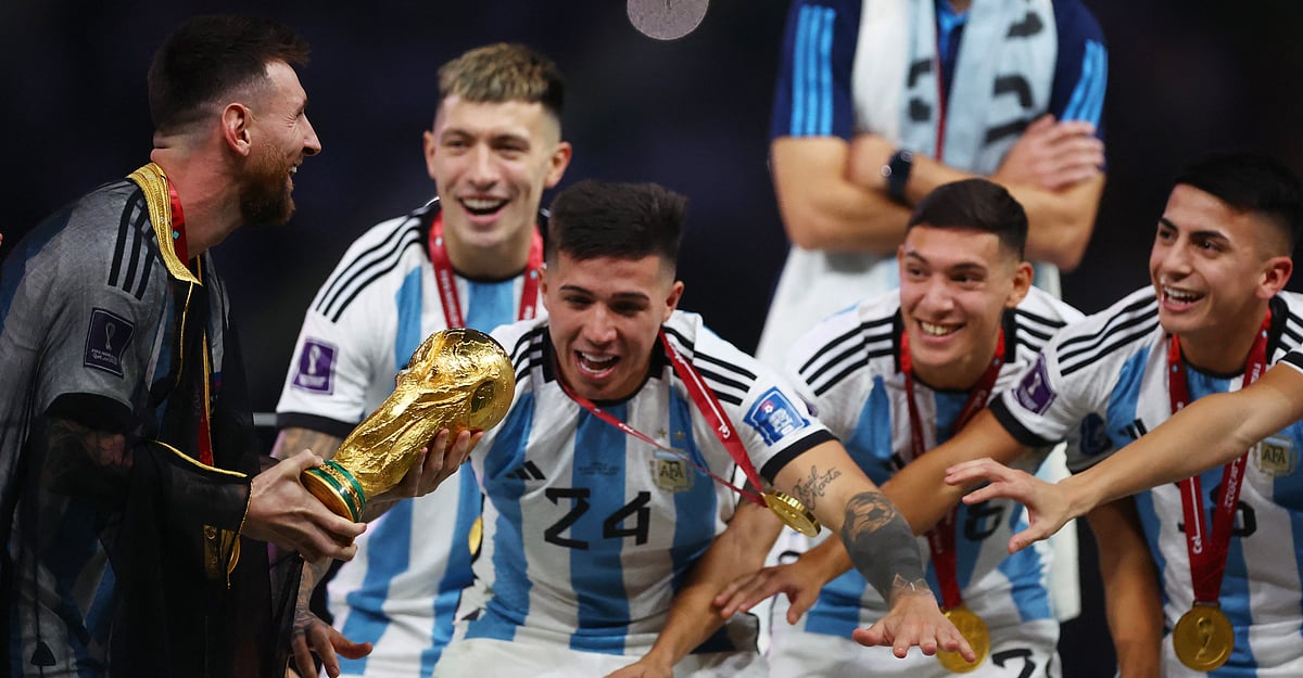 Argentina's Lionel Messi prepares to lift the trophy as they celebrate winning the World Cup
