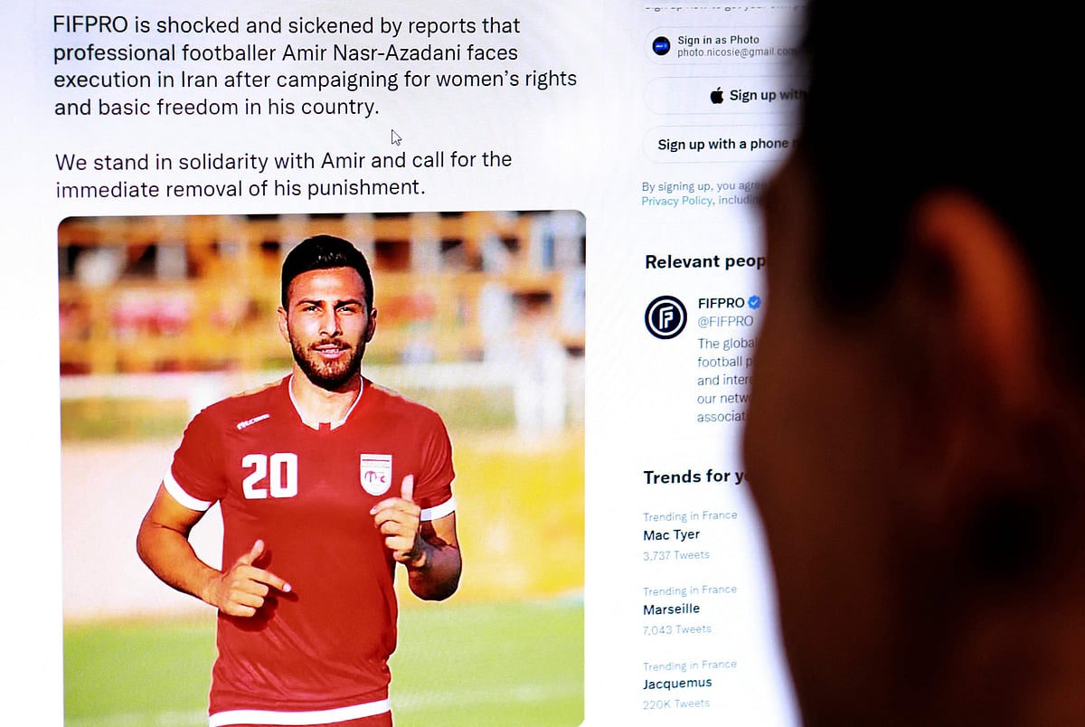 A person in the Cypriot capital Nicosia checks a tweet on 13 December, 2022, by the International Federation of Professional Footballers (FIFPRO) regarding the reported risk of Iranian footballer Amir Nasr-Azadani being sentenced to death in connection with protests