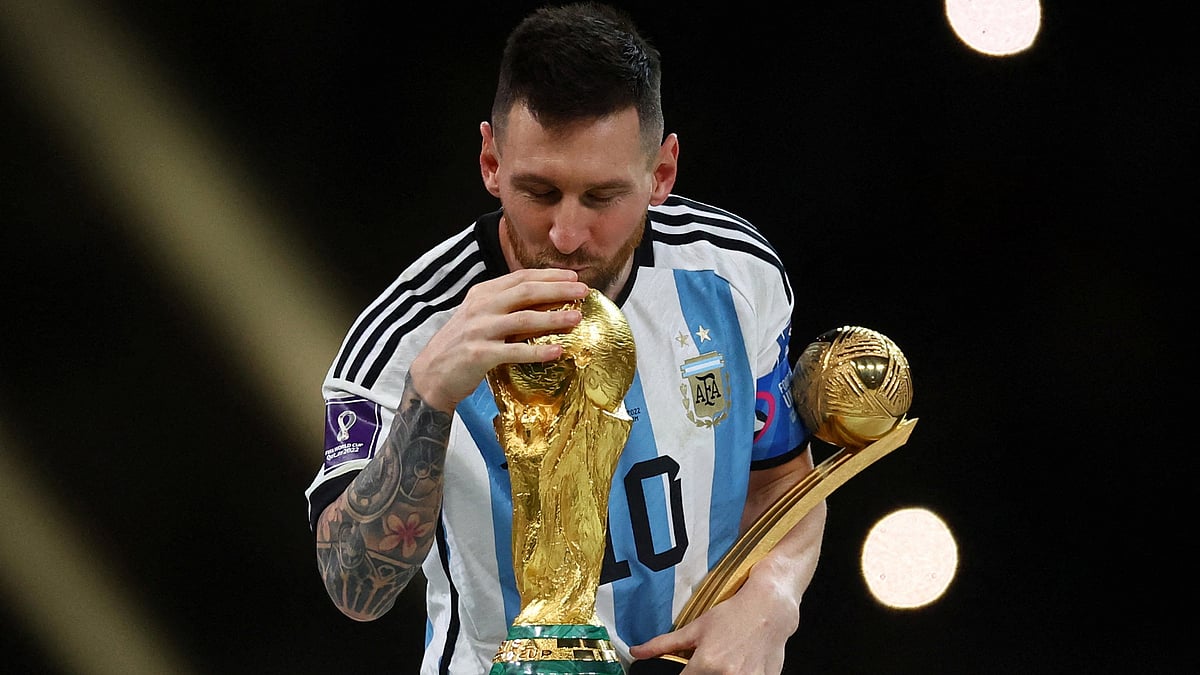 Argentina's Lionel Messi kisses the World Cup trophy after receiving the Golden Ball award as he celebrates after winning the World Cup on 18 December 2022