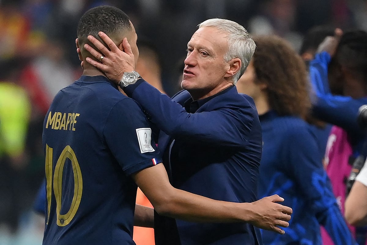 France's coach Didier Deschamps embraces France's forward Kylian Mbappe at the end of the Qatar 2022 World Cup semi-final football match between France and Morocco at the Al-Bayt Stadium in Al Khor, north of Doha on 14 December, 2022