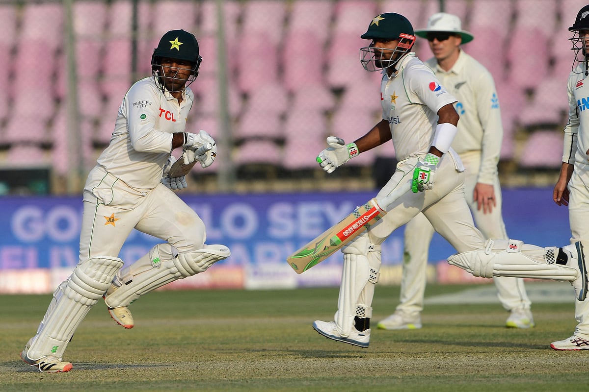 Pakistan's Sarfaraz Ahmed and captain Babar Azam run between the wickets during the first day of the first Test between Pakistan and New Zealand at the National Stadium in Karachi on 26 December, 2022
