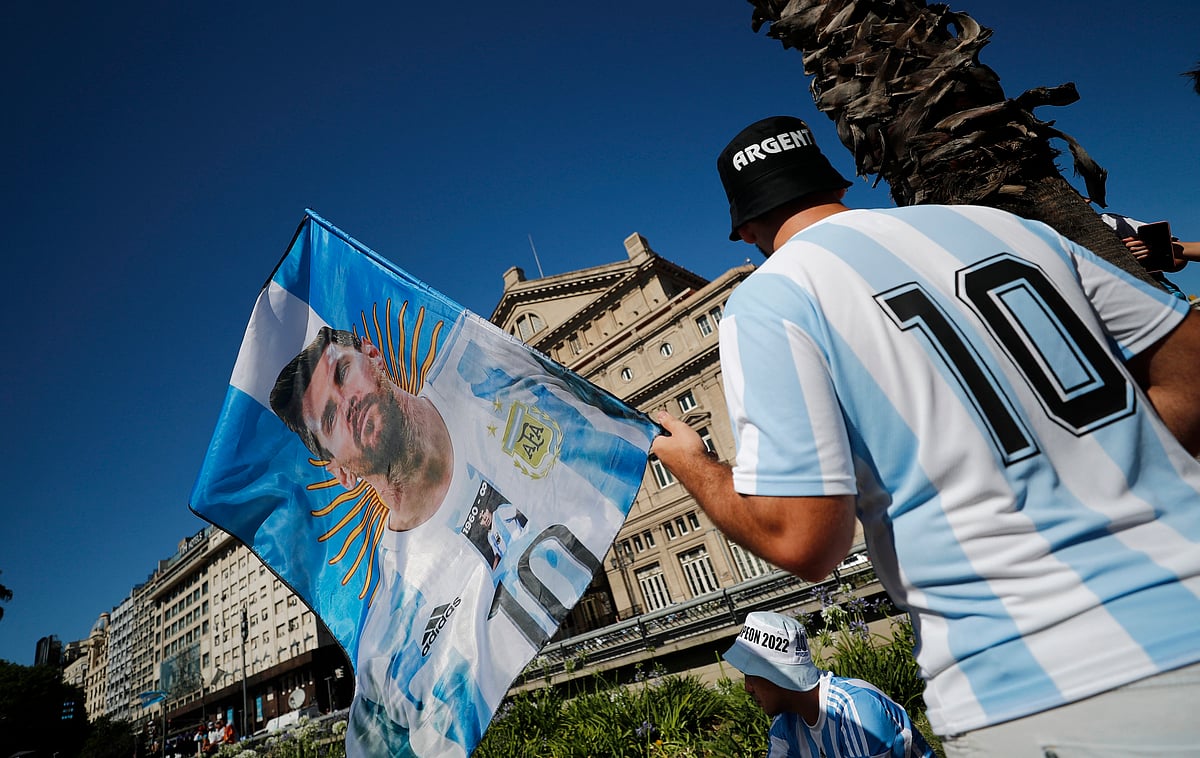 An Argentina fan displays a flag of Lionel Messi and former player Diego Maradona ahead of the victory parade Buenos Aires, Argentina on 20 December, 2022