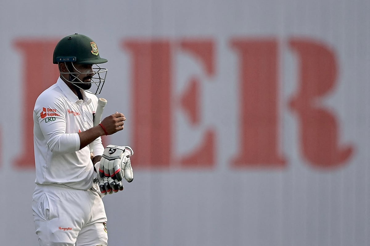 Bangladesh’s Litton Das walks off the field after being dismissed by India’s Ravichandran Ashwin during the first day of the second cricket Test match between Bangladesh and India at the Sher-e-Bangla National Cricket Stadium in Dhaka on 22 December 2022.