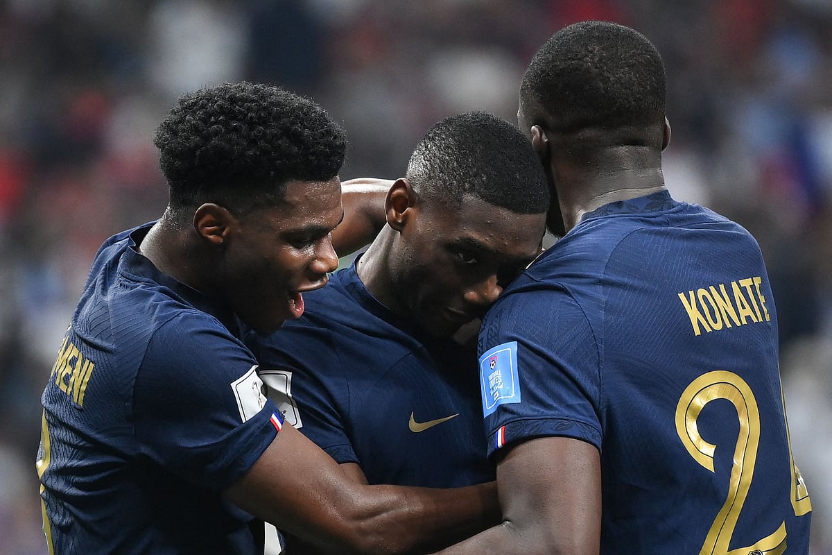 France's forward #12 Randal Kolo Muani celebrates with France's midfielder #08 Aurelien Tchouameni (L) and France's defender #24 Ibrahima Konate (R) after scoring his team's second goal during the Qatar 2022 World Cup semi-final football match between France and Morocco at the Al-Bayt Stadium in Al Khor, north of Doha on 14 December, 2022