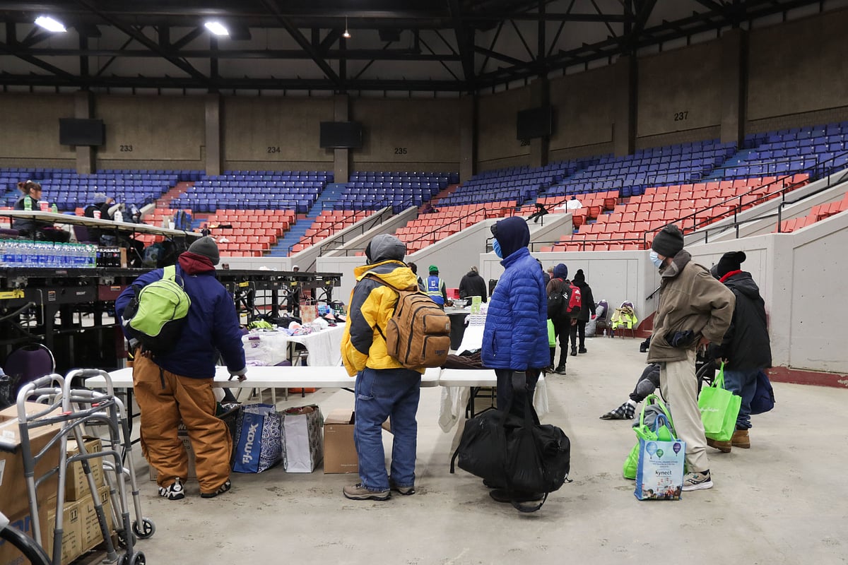 People without housing arrive at Broadbent Arena in Louisville, Kentucky, on 23 December, 2022. The arena is currently being used to provide shelter during a period of freezing temperatures.