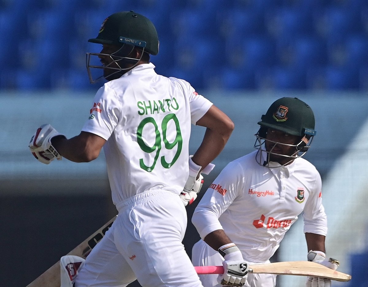 Bangladesh's Najmul Hossain Shanto (L) and Zakir Hasan (R) run between the wickets during the fourth day of the first Test between Bangladesh and India at the Zahur Ahmed Chowdhury Stadium in Chattogram on 17 December, 2022