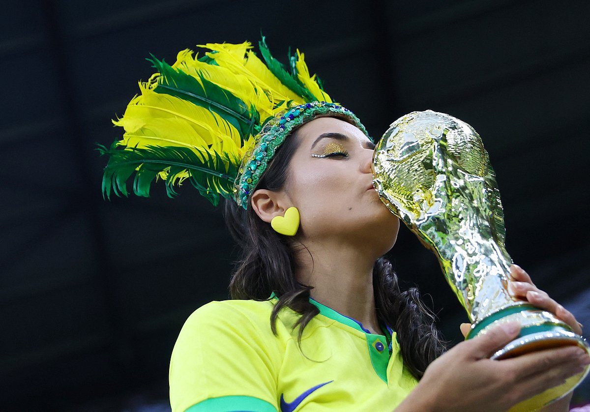 A Brazil fan is pictured with a replica World Cup trophy inside the stadium before the FIFA World Cup 2022 quarter-final match of Croatia v Brazil at the Education City Stadium in Doha, Qatar on 9 December, 2022
