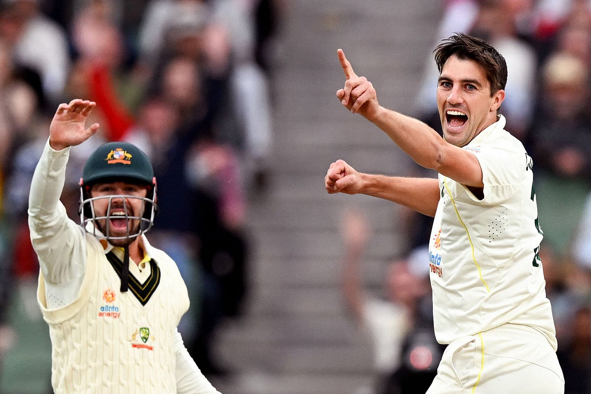 Australia's captain Pat Cummins and teammate Travis Head celebrate after dismissing South Africa's captain Dean Elgar on the third day of the second Test between Australia and South Africa at the MCG in Melbourne on 28 December, 2022