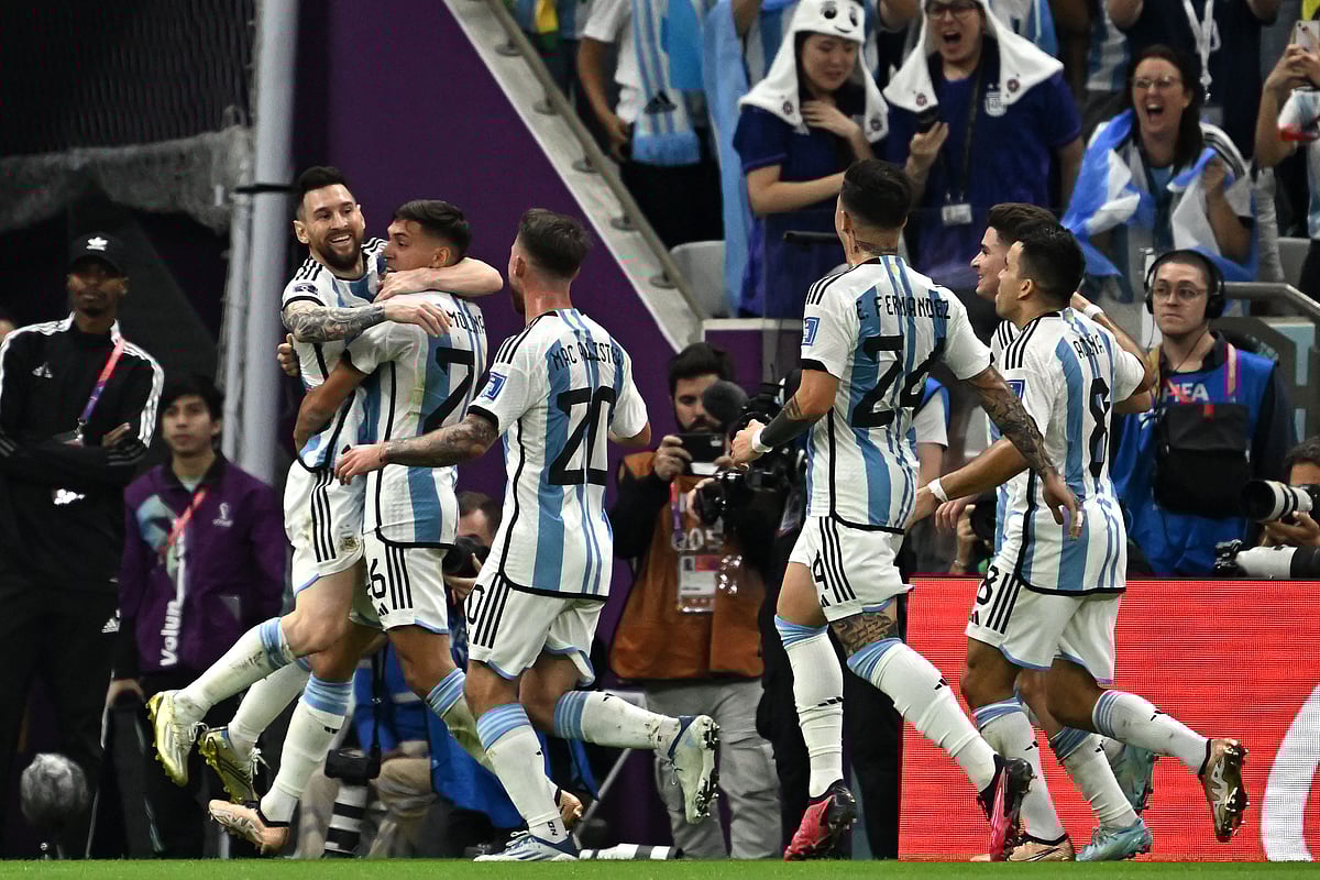 Argentina's defender Nahuel Molina celebrates with Argentina's forward Lionel Messi and teammates after scoring his team's first goal during the Qatar 2022 World Cup quarter-final football match between Netherlands and Argentina at Lusail Stadium, north of Doha, on December 9, 2022